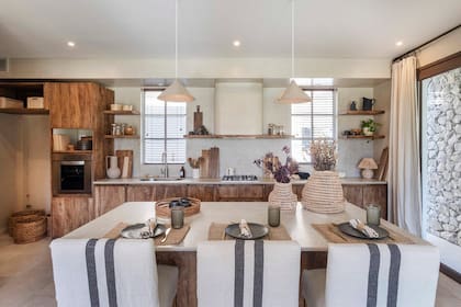 Muebles de cocina y mesa en madera castaño teñido (Familia Echaide). Ambas tienen tapa de Purastone 'Taj Mahal' (De Stefano) realizada por Marmolería Heit.