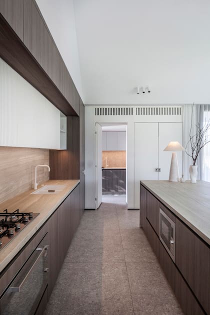 Muebles laqueados en combinación con melamina de Egger, un diseño del Estudio realizado por El Corral Home. Mesada de Neolith ‘Strata Argentum’ (United Stone). Banquetas en barra (Caro Bianco Interiors). Pileta de cocina ‘Fragranite Schock’ (Kaliteknos) y grifería blanca (Revestir).