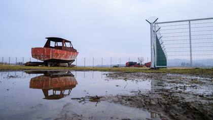 Cerca de la aldea de Gibina, Eslovenia, un casco de barco junto a una cerca a lo largo de la frontera entre Eslovenia y Croacia