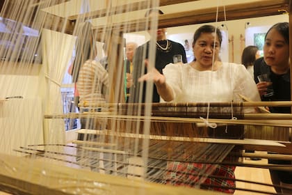 Nelia Rogano, una maestra tejedora de Kalibo, Aklan realizando tejido de piña-seda en un telar de pie en la Embajada de Filipinas en Londres