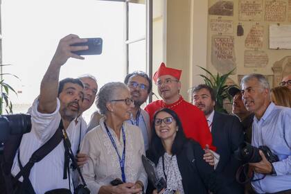 New Cardinal Américo Manuel Alves Aguiar, auxiliary bishop of Lisbon, poses for a selfie photo with journalists at the end of the consistory where Pope Francis elevated 21 new cardinals in St. Peter's Square at The Vatican, Saturday, Sept. 30, 2023. (AP Photo/Riccardo De Luca)�