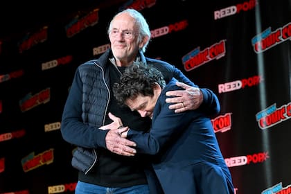 NEW YORK, NEW YORK - OCTOBER 08: Christopher Lloyd and Michael J. Fox hug onstage at the Back to the Future Reunion during New York Comic Con 2022 on October 08, 2022 in New York City. (Photo by Bryan Bedder/Getty Images for ReedPop)