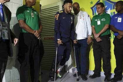 Neymar sale del estadio Mané Garrincha en muletas; este jueves se sabrá más sobre el esguince.
