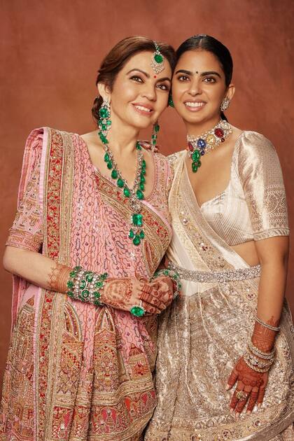 Nita e Isha Ambani, madre y hermana del novio. Isha luce un
traje del diseñador Manish Malhotra
en brocado de seda adornada con
un intrincado bordado zardozi
plateado