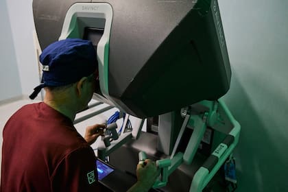 Norberto Bernardo opera desde una consola ubicada a pocos metros de la camilla, donde controla en tiempo real cada movimiento del robot