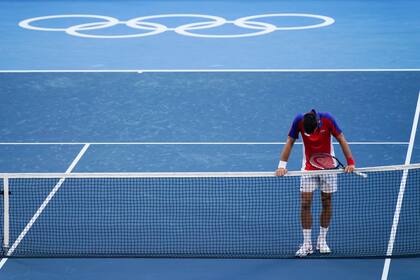 Novak Djokovic, de Serbia, reacciona luego de ser derrotado por Pablo Carreño Busta, de España, en el partido por la medalla de bronce.