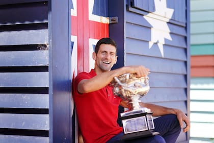 Novak Djokovic posa para la sesión de fotos del trofeo en Brighton Beach el día después de ganar su noveno Abierto de Australia, el lunes 22 de febrero de 2021.
