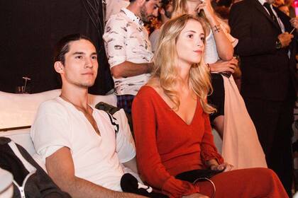 Fran Tinelli -siempre serio- junto a su novia, Martina Villar, muy elegante con un vestido rojo de mangas largas