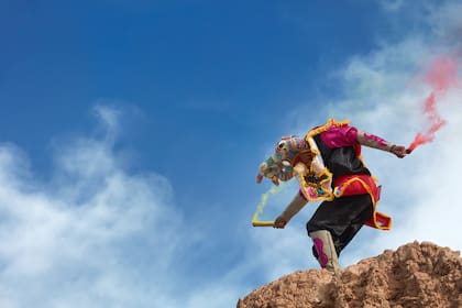 One of the "Devil's" masks of the Uquía Carnival with colorful bengala's during the "Descents of the Devil's", Jujuy province, Argentina.