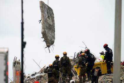 Operarios trabajan entre los escombros del edificio residencial colapsado Champlain Towers South, el 29 de junio de 2021, en Surfside, Florida