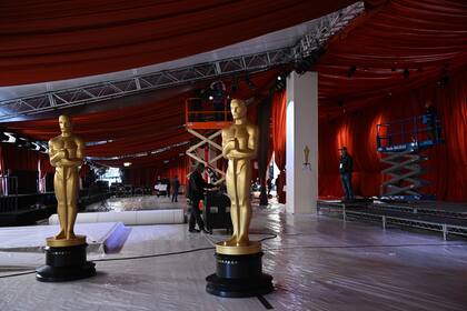 Oscar statues are seen on the champagne carpet in the celebrity arrivals area as preparations are underway for the 95th Oscars in Hollywood, California, on March 9, 2023. (Photo by Robyn BECK / AFP)