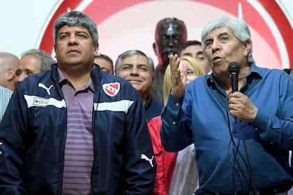 "Los jugadores van a tener que hacer un esfuerzo, entendiendo la situación. Vamos a hablar con cada uno de ellos para rever los contratos", advierte Pablo Moyano (izquierda), vicepresidente de Independiente, club encabezado por su padre, Hugo (derecha).