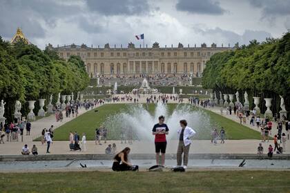 Los visitantes disfrutan de los jardines del Palacio de Versalles, en las afueras de París, Francia, el 15 de julio de 2023