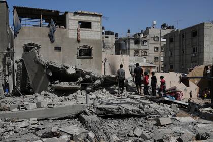 Palestinos miran a una casa atacada por el ejército israelí en Jan Yunis, en la Franja de Gaza, el sábado 3 de mayo