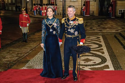 Para esta ocasión especial, Mary recuperó el diseño de Birgit Hallstein que estrenó el 25 de abril de 2024 en su primer retrato oficial como Reina. Se trata de un vestido con cuerpo de terciopelo verde coordinado cromáticamente con el encaje que cubre mangas y escote. Y lo acompañó con la tiara de esmeraldas a juego con unos pendientes tipo chandelier, gargantilla y broche, todo del cofre real. Complementó el conjunto con stilettos Gianvito Rossi y clutch de cristales de J. Furmani, y llevó su insignia de la Family Order con la foto del Rey y el collar de la Orden del Elefante. Federico vistió el uniforme militar de gala de la Marina.