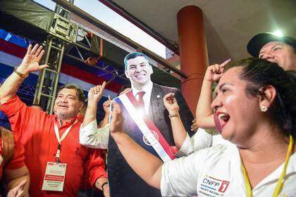 Partidarios del candidato presidencial paraguayo por el Partido Colorado, Santiago Peña, celebran después de conocer los primeros resultados de las elecciones generales y presidenciales en Asunción el 30 de abril de 2023