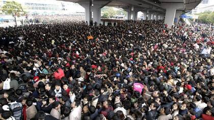 Pasajeros tratando de ingresar a la estación de trenes de Cantón, China