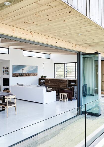 Pasando un living práctico y austero, se llega al cuarto de huéspedes, revestido en madera como la fachada