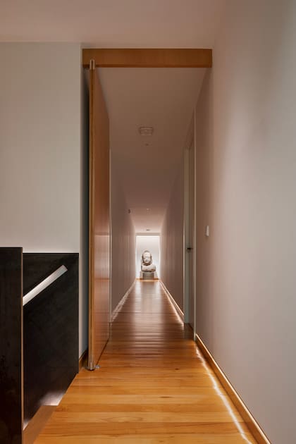 Pasillo principal que conduce a todos los dormitorios. Al final, un Buda indonesio del siglo XIX, que acompaña al arquitecto Gronda en todas sus casas desde 1995.