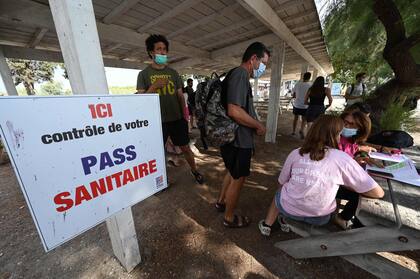 Pedidos de pase sanitario en Aigues Mortes, en el sur de Francia (Photo by Pascal GUYOT / AFP)