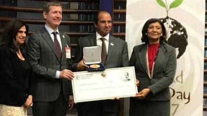 Pedro Vigneau (centro) al recibir el premio