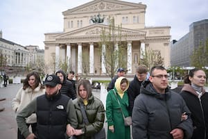 People walk on a square in front of the Bolshoi theatre in Moscow on May 13, 2024. (Photo by NATALIA KOLESNIKOVA / AFP)