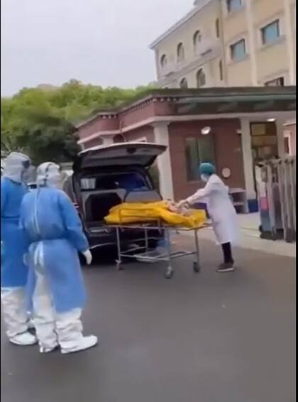 Personal de la funeraria y del hogar de ancianos revisan la bolsa de cadáveres en la que se encuentra el hombre con vida