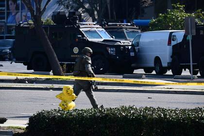 Personal de las fuerzas del orden en el exterior del lugar de Torrance, California, donde se cree que se esconde el presunto sospechoso del tiroteo masivo en el que murieron 10 personas en Monterey Park, California. 