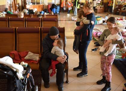 Personas descansan en una sala especial para refugiados en una estación de tren en Lviv, al oeste de Ucrania