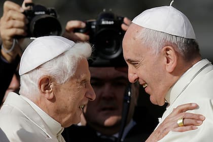 Pope Francis, right, embraces Pope Emeritus Benedict XVI before the start of a meeting with elderly faithful in St. Peter's Square at the Vatican, September 28, 2014