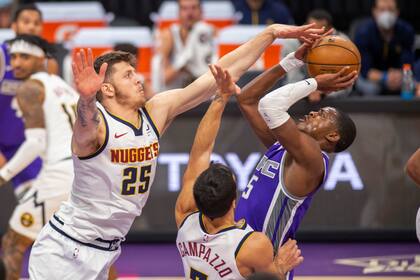 Por la lesión de Jamal Murray, el base titular, Facundo Campazzo tuvo algo más de acción en Denver; en la imagen, con su compñaero Isiah Hartenstein intentan detener al goleador de Sacramento, DeAron Fox