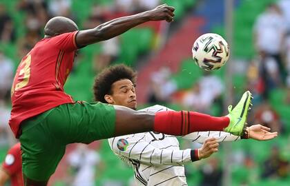 Portugal's Danilo Pereira challenges Germany's Leroy Sane during the Euro 2020 soccer championship group F match between Portugal and Germany at the football arena stadium in Munich, Saturday, June 19, 2021. (Christof Stache/Pool via AP)