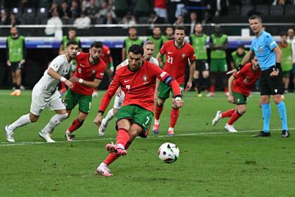 Portugal's forward #07 Cristiano Ronaldo takes the penalty shot during the UEFA Euro 2024 round of 16 football match between Portugal and Slovenia at the Frankfurt Arena in Frankfurt am Main on July 1, 2024. (Photo by JAVIER SORIANO / AFP)