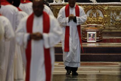 Priests attend the funeral service of Cardinal Leon Kalenga Badikebele, the Apostolic nuncio in Argentina, at St. Peters Basilica at the Vatican, Saturday, June 15, 2019. (AP Photo/Gregorio Borgia)
