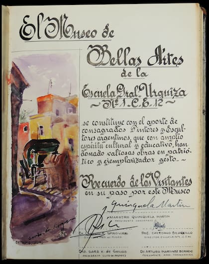 Primera página del libro de oro escolar con el reconocimiento y firma de Quinquela Martín