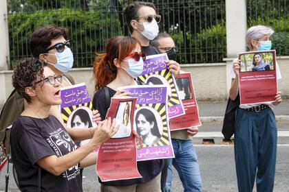 Protesters stage a demonstration near the Iranian embassy on the occasion of the one-year anniversary of the death of 22-year-old Mahsa Amini, in Rome, Saturday, Sept. 16, 2023. Amini died following her arrest by the Iran's morality police for allegedly violating the country's mandatory headscarf rule. (Mauro Scrobogna/LaPresse via AP)�