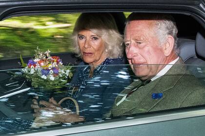 Britain's King Charles III (R) and Britain's Queen Camilla (L) leave after attending church in the village of Crathie, near Balmoral in central Scotland on September 8, 2023, on the first anniversary of the passing of his mother, Queen Elizabeth II. Britain on Friday, September 8, mark the first anniversary of Queen Elizabeth II's death but commemorations will be low-key with no official public events planned. (Photo by ANDY BUCHANAN / AFP)