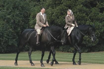 Queen Elizabeth II riding in the grounds of Windsor Castle with US President Ronald Reagan, during his state visit to the UK, 8th June 1982. She is riding her horse 'Burmese' abd he is mounted on 'Centennial', both gifts to the Queen from the Canadian Mounted Police. (Photo by Georges De Keerle/Getty Images)