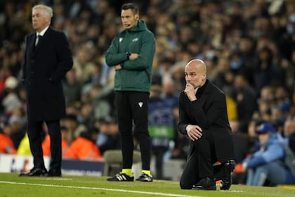 Real Madrid's head coach Carlo Ancelotti and Manchester City's head coach Pep Guardiola watch the game during the Champions League quarterfinal second leg soccer match between Manchester City and Real Madrid at the Etihad Stadium in Manchester, England, Wednesday, April 17, 2024. (AP Photo/Dave Thompson)