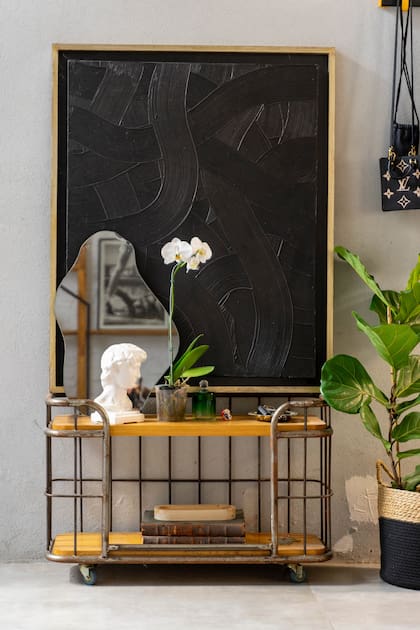 Recibidor con espejo y escultura de Remy Studio