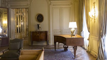 Las salas se replican entre grandes cortinados antiguos y pesados, aberturas de bronce de minucioso diseño, tapizados, boiseries con destellos dorados y candelabros