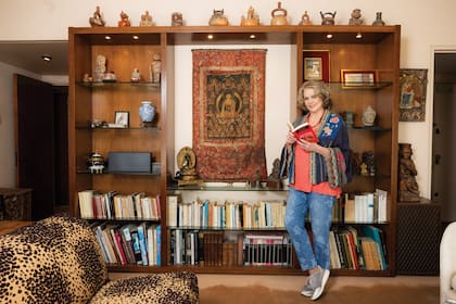 Regina posa en el living de su casa, donde atesora recuerdos de sus viajes y de los viajes de sus padres. “Aprendí de ellos el valor del respeto por el otro, de la tolerancia, del trabajo, del juego… Lo importante que es decir la verdad, ser curioso y querer aprender”, cuenta.
