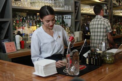 Rep. Alexandria Ocasio-Cortez, D-N.Y., mixes margaritas while tending bar at a restaurant in the Queens borough of New York, Friday, May 31, 2019. She was back in her New York district tending bar as part of her push to raise the federal minimum wage, especially for workers who now depend on tips. (