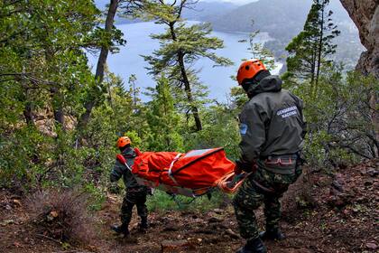 Dos rescatistas con la camilla, fabricada en Italia, que se puede plegar y llevar en la mochila hasta llegar al lugar donde está la persona afectada.