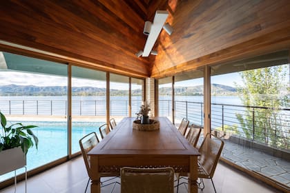 Restauraron la mesa que antes estaba en el comedor y aclararon el tono de la madera. Colgada del techo instalaron la misma bandeja con spots (Huup) que en el living.