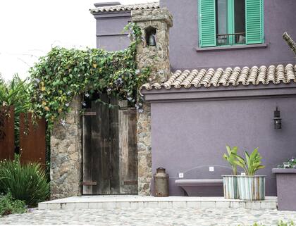 Revestida en Tarquini cementicio y piedra Cascarón de Córdoba, el aspecto exterior de la casa con sus tejas y la piedra bola en el piso, luce también un estilo colonial.