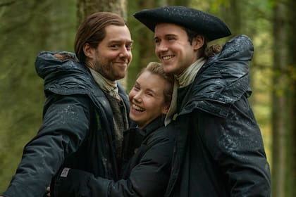 Richard Rankin, y la pareja en la ficción conformada por Lauren Lyle y César Domboy, se divierten en medio de la lluvia que caracteriza a la mayoría de los rodajes de Outlander