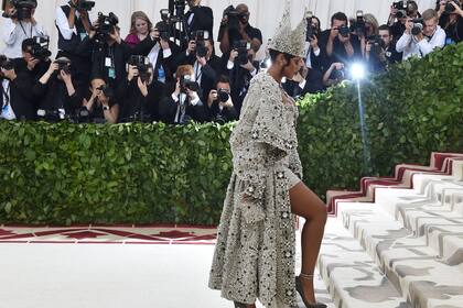 Rihanna arrives for the 2018 Met Gala on May 7, 2018, at the Metropolitan Museum of Art in New York. The Gala raises money for the Metropolitan Museum of Art’s Costume Institute. The Galas 2018 theme is “Heavenly Bodies: Fashion and the Catholic Imagination.” / AFP PHOTO / Hector RETAMAL