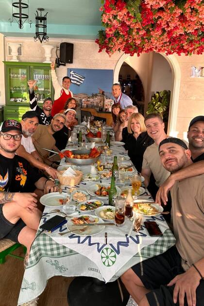 Rodrigo de Paul disfrutó el día libre de la selección tras el pase a la final en un restaurante griego; se lo ve al fondo de la imagen y delante de él, con una gorra blanca, está su cuñado Fran Stoessell