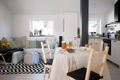 Sin demasiada posibilidad de ubicar bibliotecas, los antepechos de las ventanas dan apoyo a libros y deco, como la piña negra de cerámica (Sacum) y la maceta de madera (Natura). En la página opuesta, Marta Prats, encargada de esta remodelación